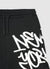 Pantaloncini oversize con maxi scritta