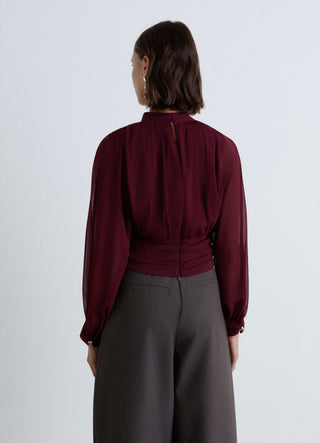 Blusa plissé con collo alto