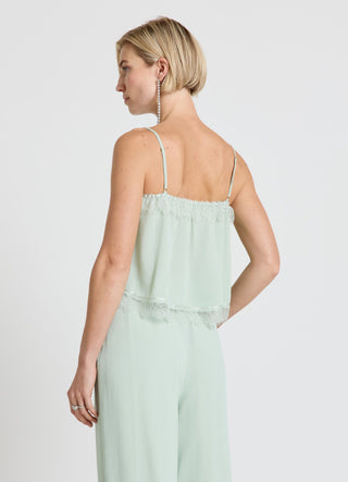 Top con balze e inserti in pizzo